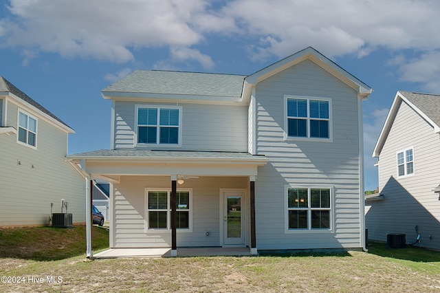 view of front of property with a shingled roof, ceiling fan, a front lawn, and central AC unit