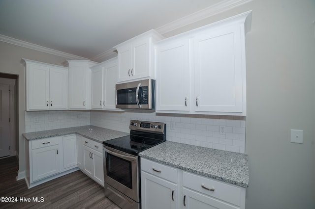 kitchen with white cabinets, ornamental molding, stainless steel appliances, and backsplash