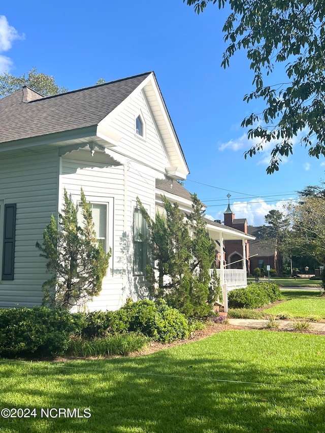 view of property exterior with a lawn