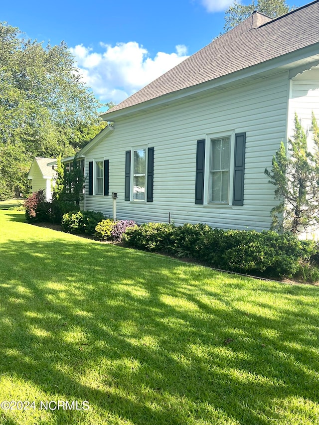 view of property exterior featuring a lawn