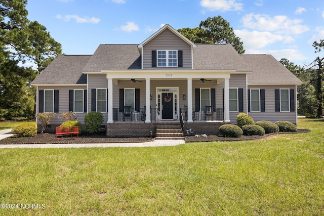 view of front of house with a porch, ceiling fan, and a front yard