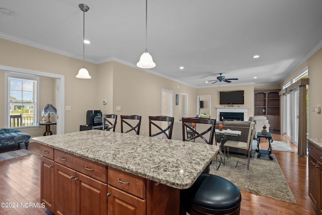 kitchen featuring a breakfast bar area, dark hardwood / wood-style floors, and ceiling fan