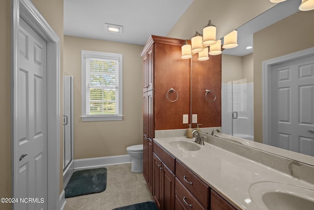 full bath with double vanity, a stall shower, baseboards, and a sink