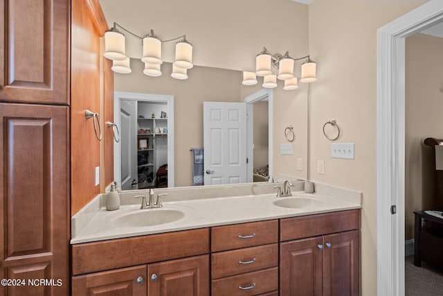 ensuite bathroom with double vanity, a sink, and ensuite bathroom