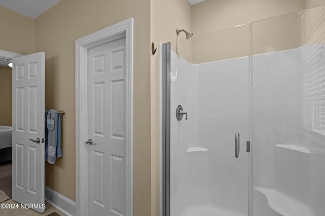 bathroom with a shower with shower door