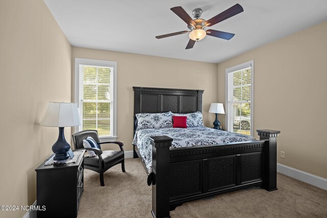 bedroom featuring light colored carpet and ceiling fan