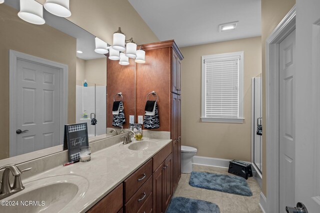 bathroom with a shower with shower door, tile patterned flooring, toilet, and vanity