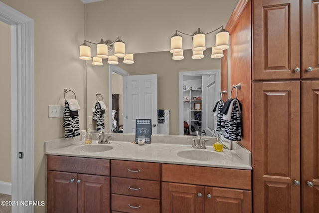 bathroom featuring double vanity, a closet, and a sink