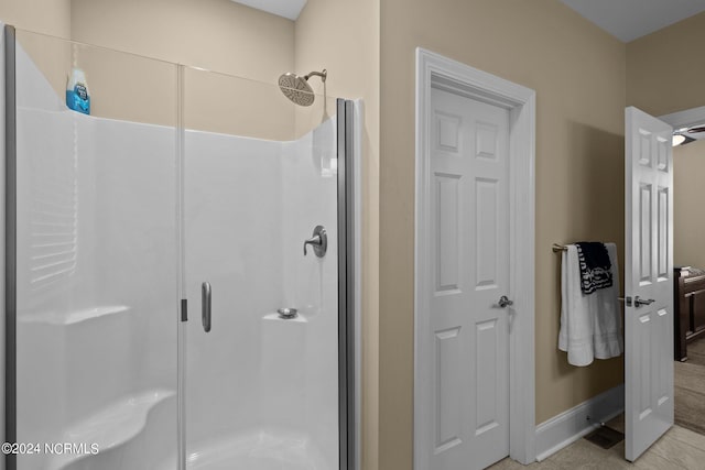 full bathroom featuring a stall shower and baseboards