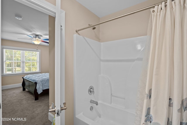 bathroom with ceiling fan, baseboards, and shower / tub combo with curtain