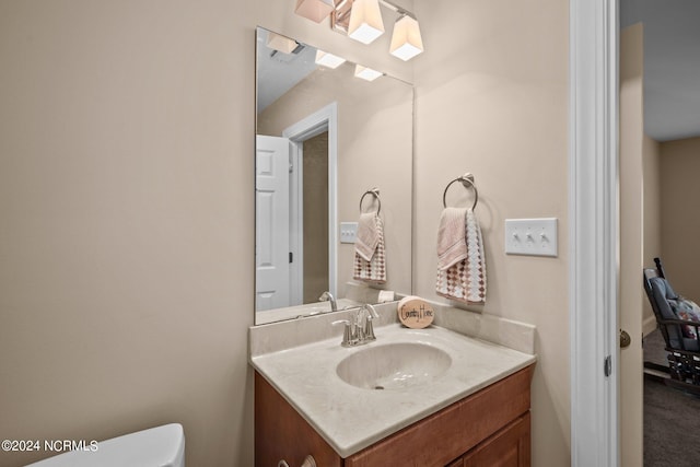 bathroom with toilet and vanity