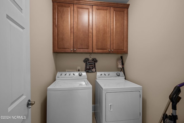 washroom with cabinet space and separate washer and dryer