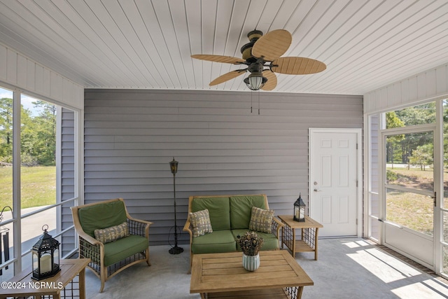 sunroom / solarium featuring ceiling fan