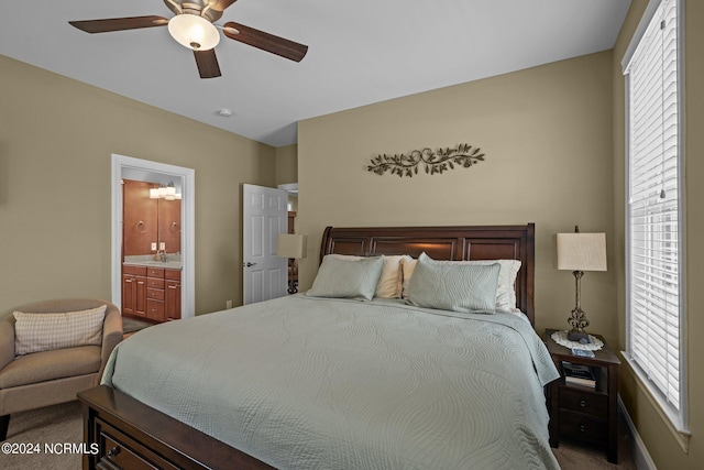 carpeted bedroom with a sink, ceiling fan, and connected bathroom