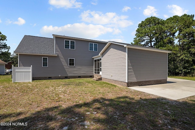 back of property with entry steps, a yard, crawl space, and a patio