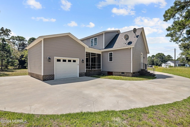 view of front facade featuring a garage and a sunroom