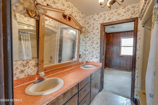 bathroom featuring shower / tub combo, vanity, and wood walls