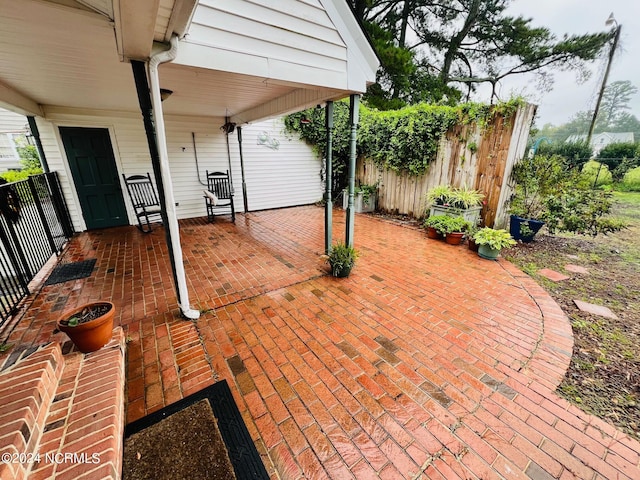 view of patio / terrace featuring fence