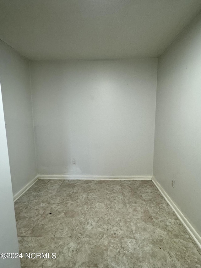 spare room with baseboards