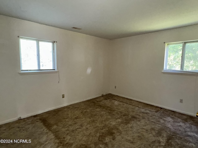 carpeted empty room with visible vents