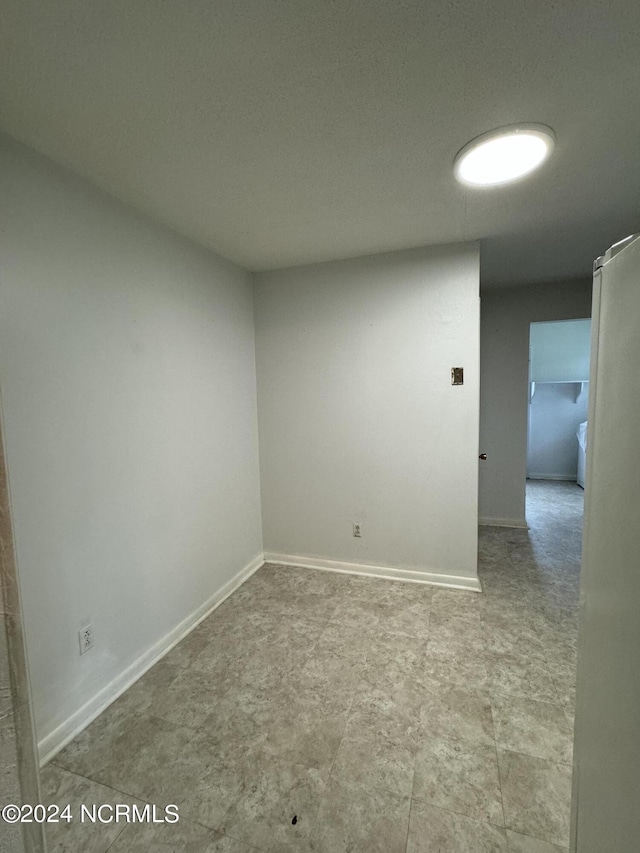 spare room with baseboards