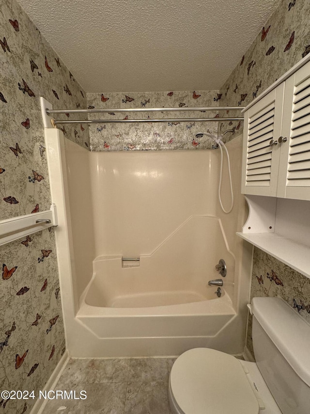 full bathroom with toilet, wallpapered walls, a textured ceiling, and bathing tub / shower combination