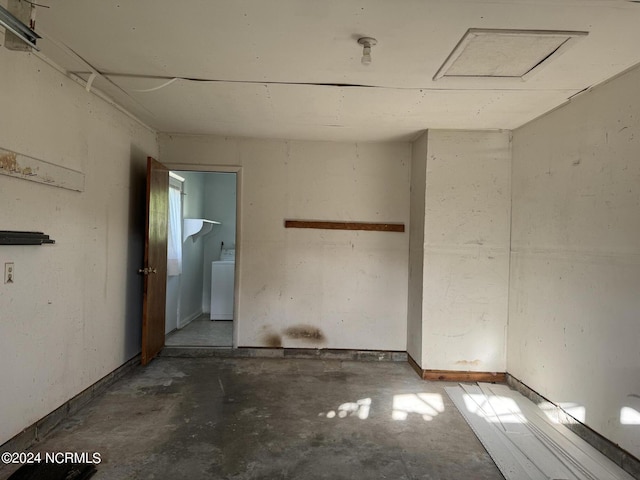 unfurnished room featuring washer / dryer and unfinished concrete floors