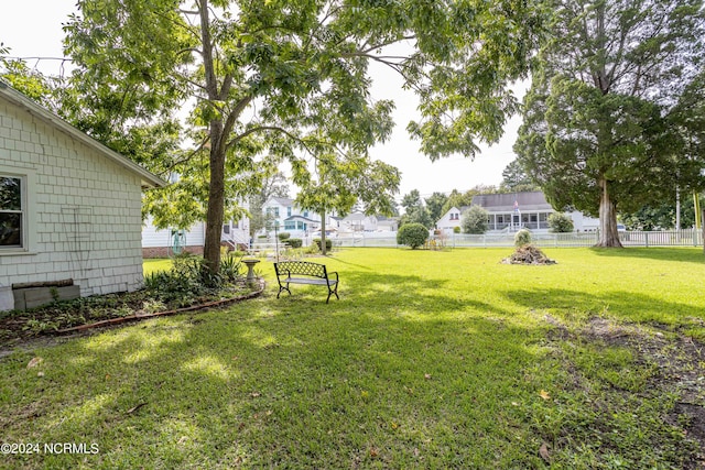 view of yard featuring a residential view and fence