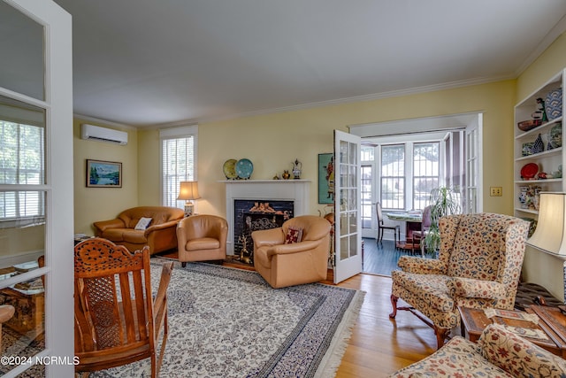 living area with a wall unit AC, plenty of natural light, ornamental molding, and french doors