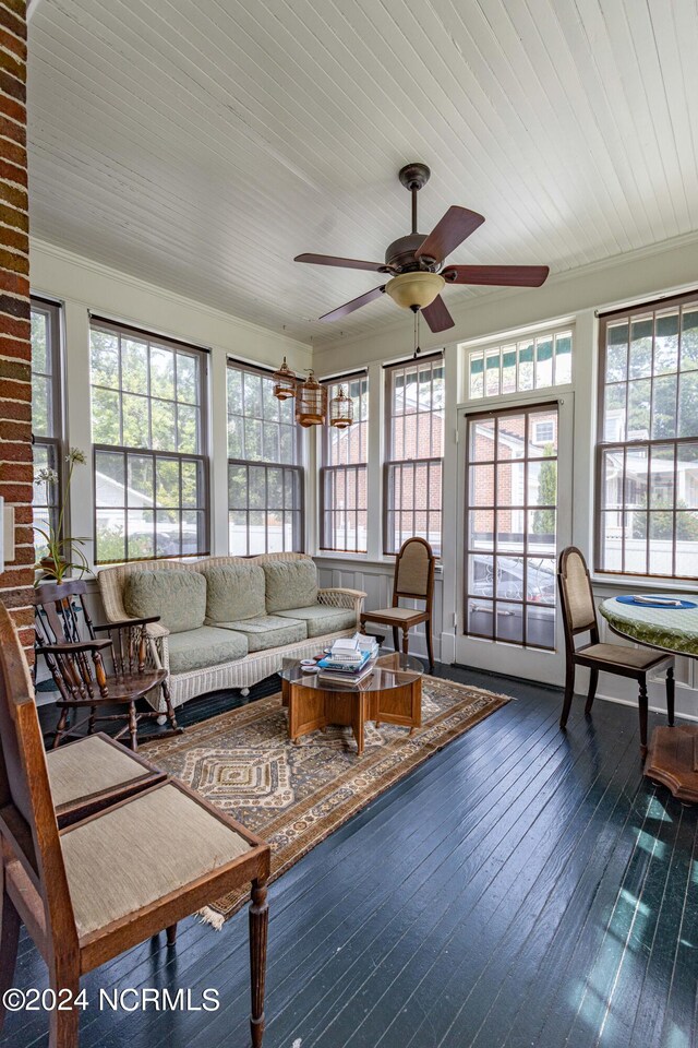 sunroom with a wealth of natural light, wooden ceiling, and ceiling fan