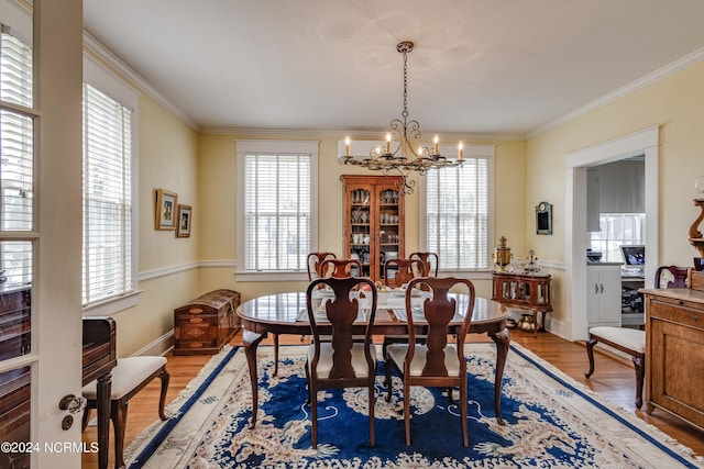 dining room featuring hardwood / wood-style floors, an inviting chandelier, and a healthy amount of sunlight