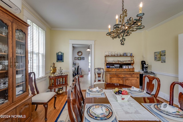 dining space featuring a notable chandelier, hardwood / wood-style floors, ornamental molding, and a wall mounted air conditioner