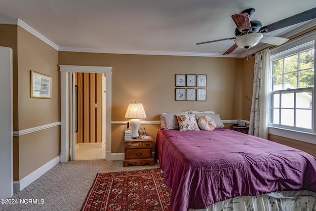 carpeted bedroom featuring ceiling fan and crown molding