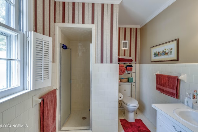 bathroom with a shower with door, vanity, and tile walls