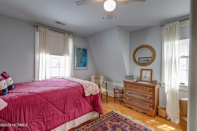 bedroom featuring ceiling fan, light wood finished floors, and visible vents