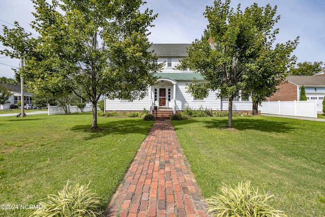 obstructed view of property featuring a front yard