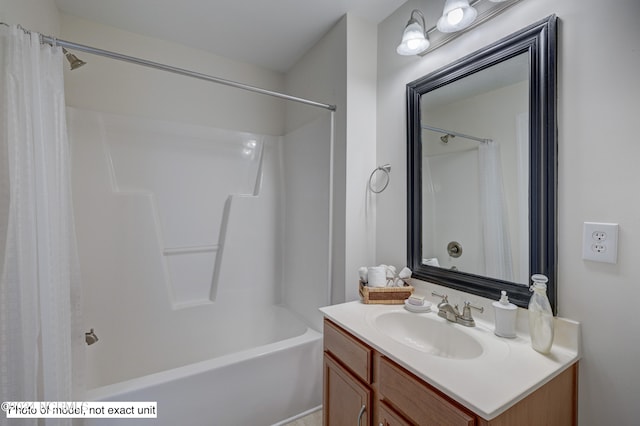 bathroom featuring shower / tub combo and vanity