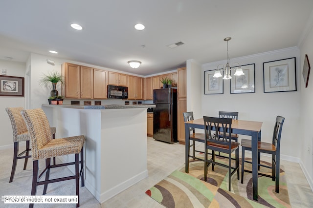 kitchen featuring decorative light fixtures, light colored carpet, a notable chandelier, black appliances, and ornamental molding