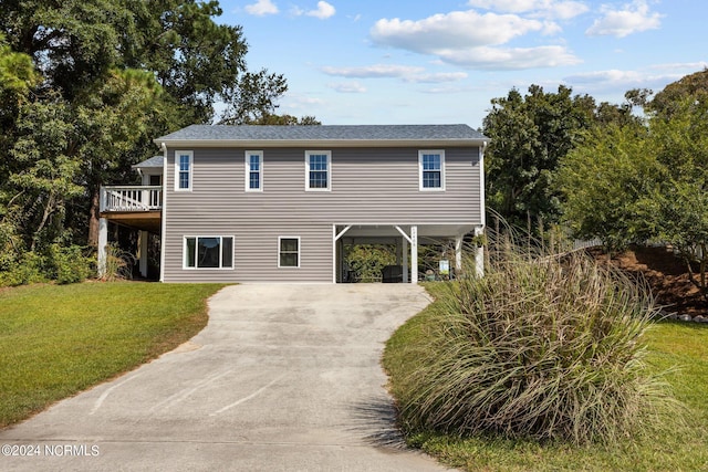 view of front facade featuring a front lawn and a carport