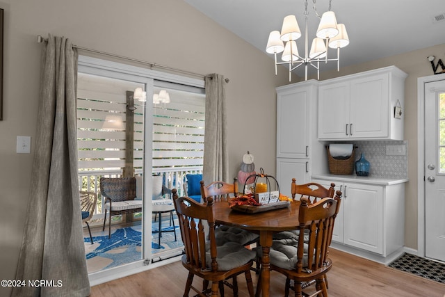 dining area featuring light hardwood / wood-style flooring and an inviting chandelier