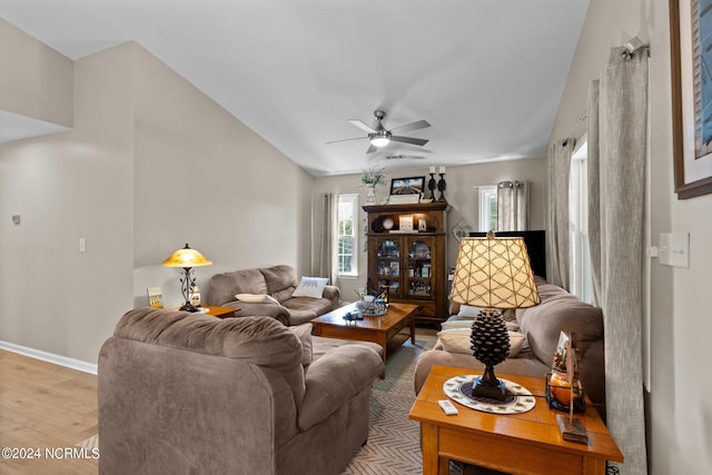 living room featuring ceiling fan, light wood-type flooring, and lofted ceiling