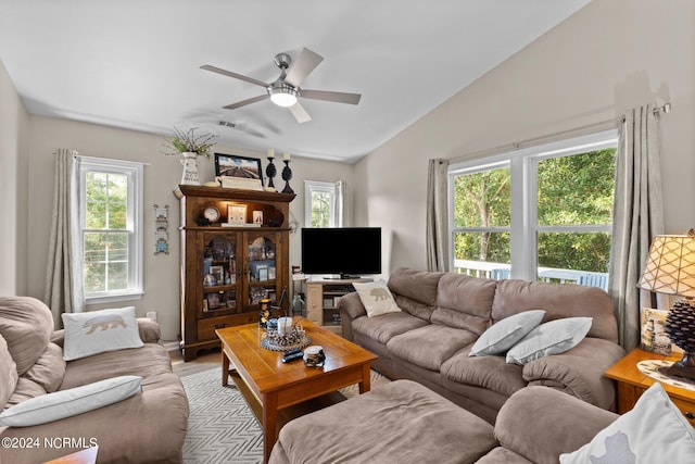 living room featuring ceiling fan and lofted ceiling