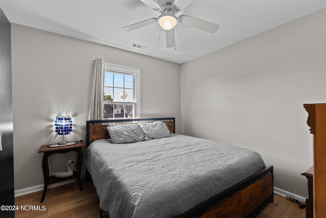 bedroom featuring ceiling fan and dark hardwood / wood-style floors