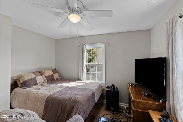 bedroom with ceiling fan and hardwood / wood-style floors