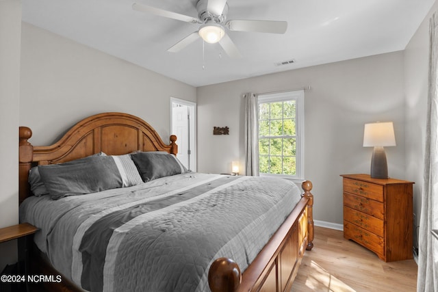 bedroom with ceiling fan and light hardwood / wood-style floors