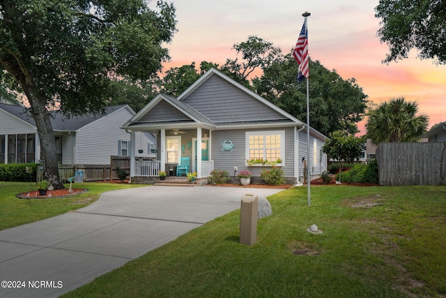 view of front of house with covered porch and a lawn