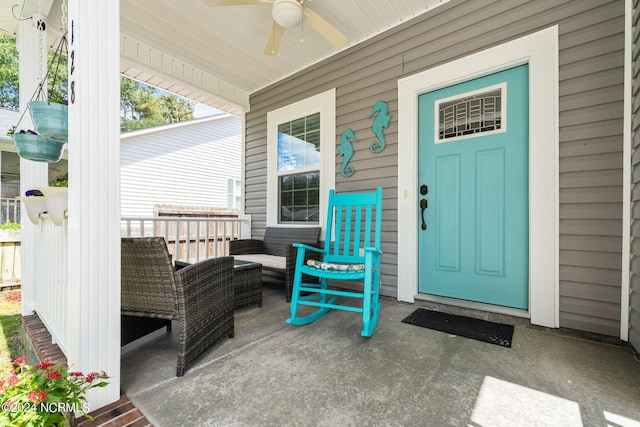 entrance to property with a ceiling fan and covered porch