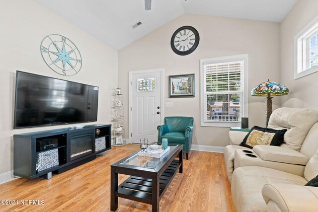 living room featuring hardwood / wood-style flooring and vaulted ceiling