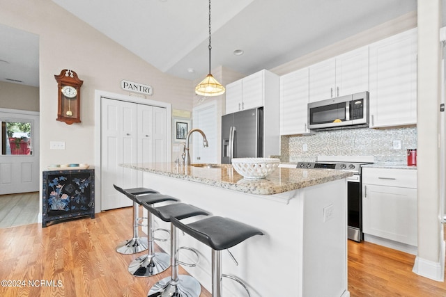 kitchen with white cabinetry, sink, a center island with sink, and appliances with stainless steel finishes