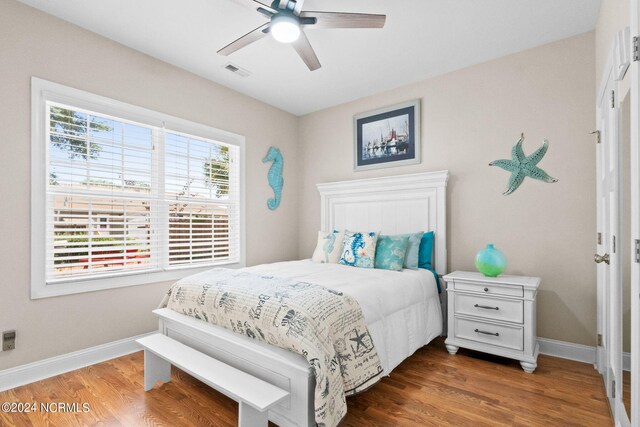 bedroom with ceiling fan and dark hardwood / wood-style floors